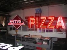 Open face channel letters illuminated with red Neon