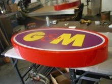 Single face aluminum logo with reverse vinyl lettering illuminated with LEDS